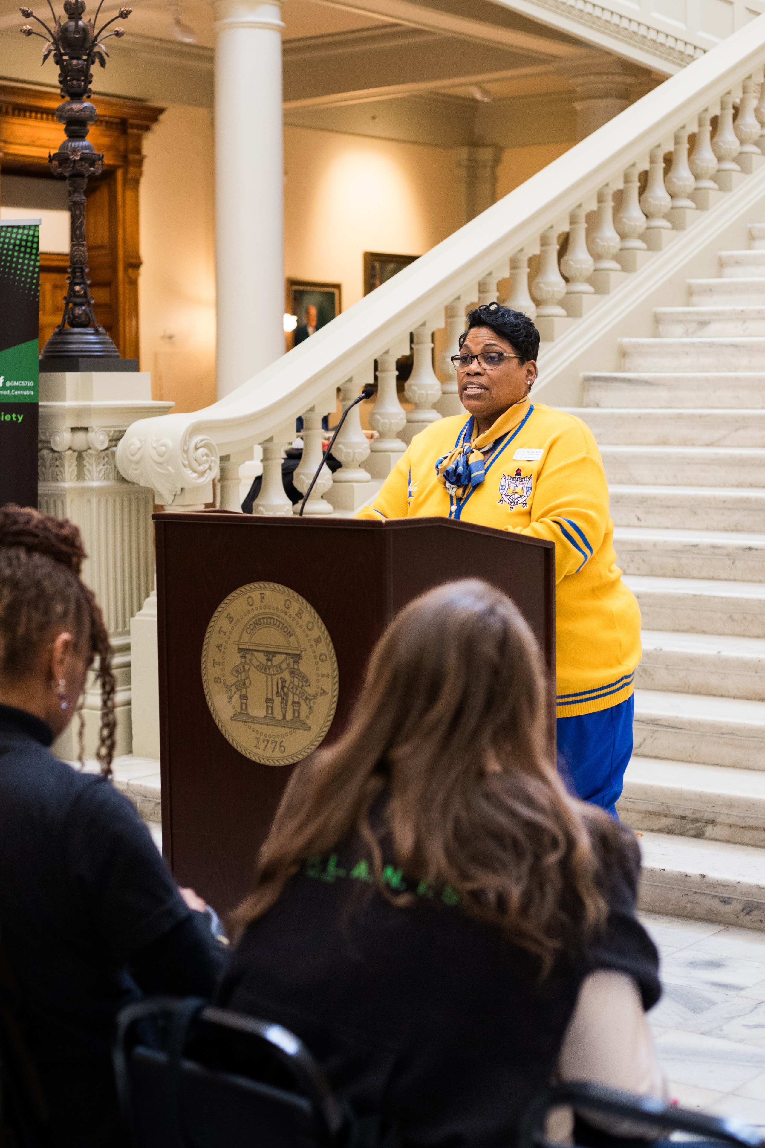 Woman speaking at government podium