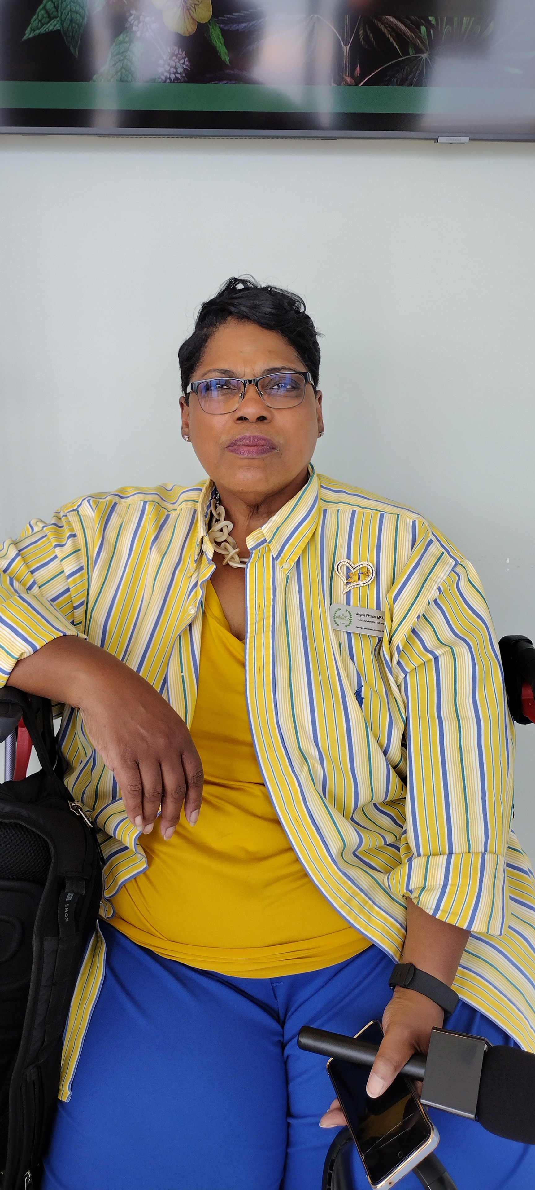 Woman in striped blazer, seated portrait